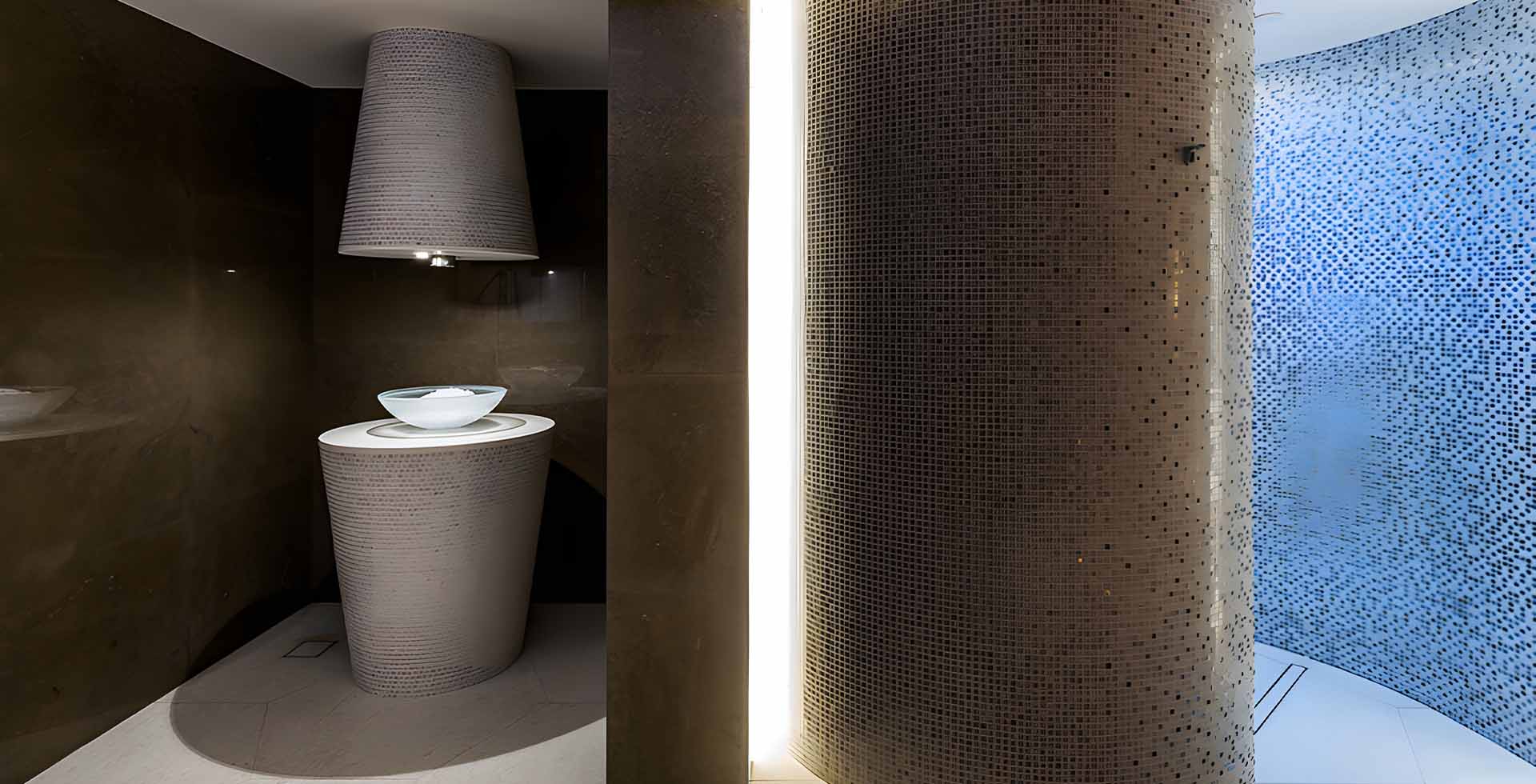 Ice fountain in the wet area of a hotel spa in Doha: a mosaic-clad conical pedestal holding a glass bowl under a matching mosaic hood with a downlight, a floor grating at its base