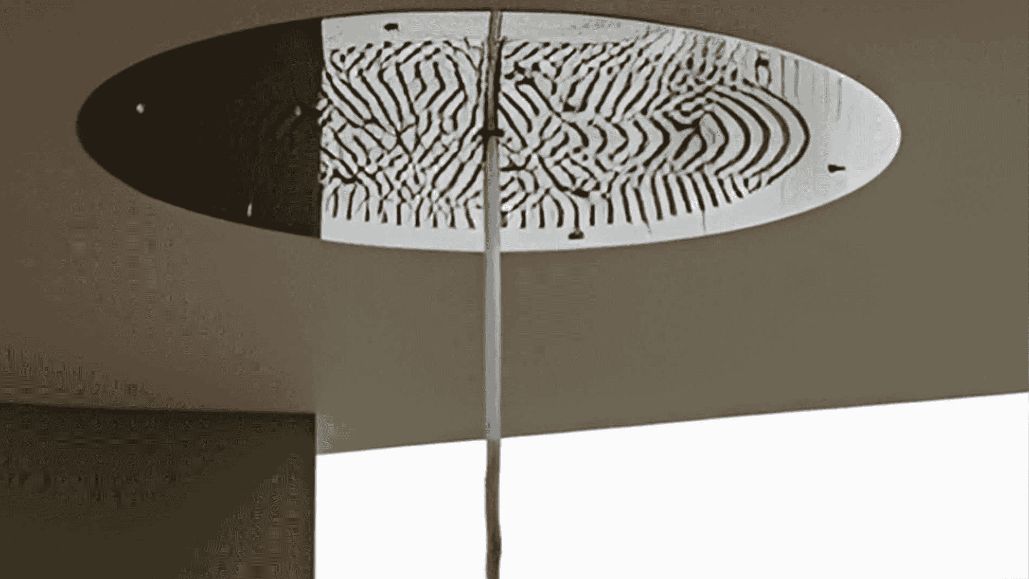 Ceiling-mounted adventure shower panel with a patterned oval face and a vertical supply column